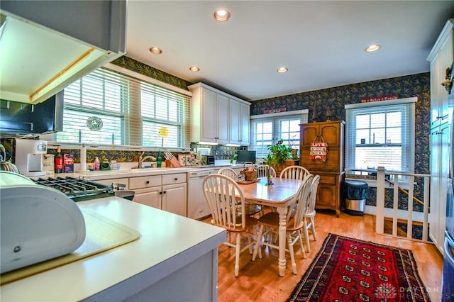 401 Hadley Ave, Dayton, OH 45419 - kitchen featuring white dishwasher, wallpapered walls, light countertops, light wood-style floors, and recessed lighting