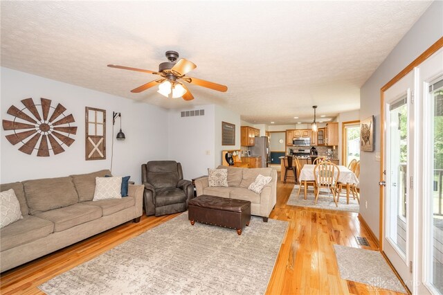 143 Summerfield Ln, Lebanon, OH 45036 - living area featuring light wood-type flooring, a ceiling fan, and a textured ceiling