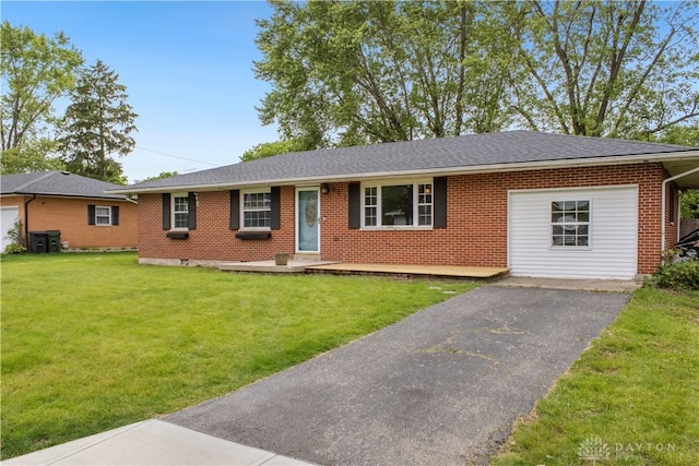 807 Fallview Ave, Englewood, OH 45322 - ranch-style house featuring brick siding, asphalt driveway, a front lawn, and roof with shingles