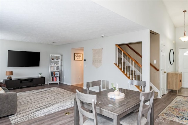 4171 Loyala Chase Ln, Fairborn, OH 45424 - dining space featuring wood finished floors, stairway, baseboards, and a textured ceiling
