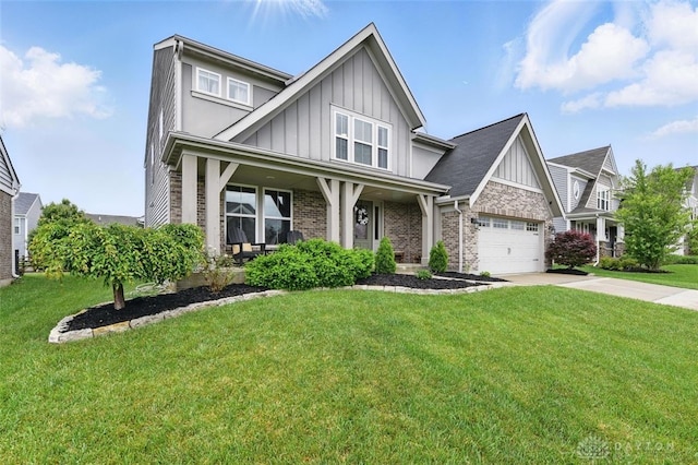 1535 Mulberry Ct, Turtlecreek Twp, OH 45036 - view of front facade with board and batten siding, driveway, a front lawn, and brick siding