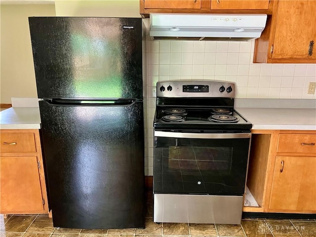 201 Applegate Rd, Union, OH 45322 - kitchen featuring freestanding refrigerator, electric range, exhaust hood, light countertops, and backsplash