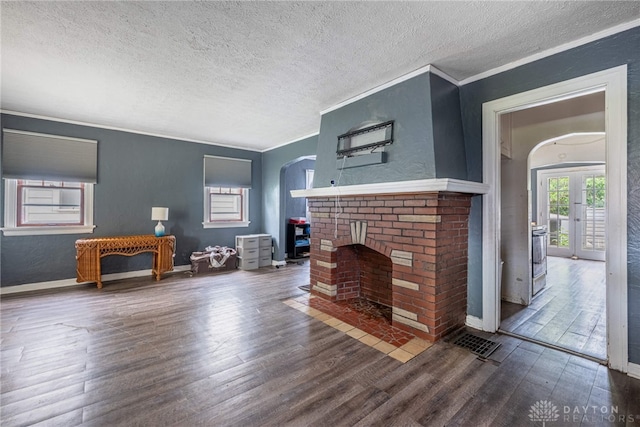 57 W Maplewood Ave, Dayton, OH 45405 - living area with a textured ceiling, wood finished floors, arched walkways, ornamental molding, and a brick fireplace