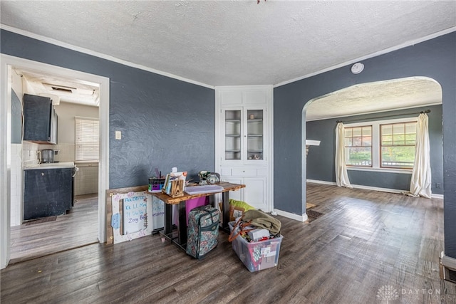 57 W Maplewood Ave, Dayton, OH 45405 - dining room featuring arched walkways, a textured ceiling, plenty of natural light, wood finished floors, and ornamental molding