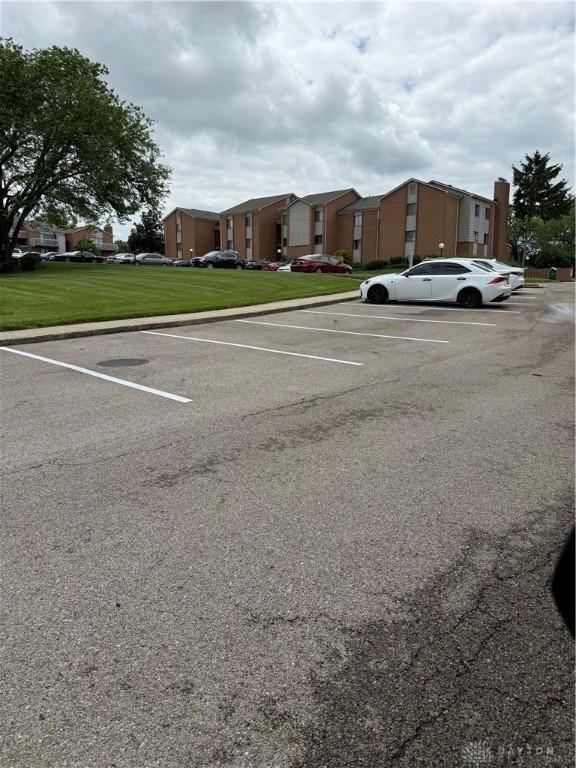 1109 Arrowhead Xing Unit A, West Carrollton, OH 45449 - uncovered parking lot featuring a residential view