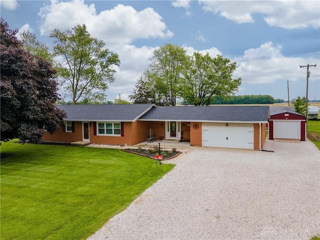 4510 W State Route 185, Piqua, OH 45356 - ranch-style house with driveway, a front yard, a garage, and brick siding