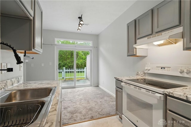 9670 Centerville Creek Ln, Washington Twp, OH 45458 - kitchen featuring electric stove, under cabinet range hood, gray cabinets, light colored carpet, and baseboards