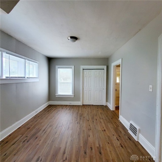 1271 Highland Ave, Dayton, OH 45410 - unfurnished bedroom featuring wood finished floors and a closet