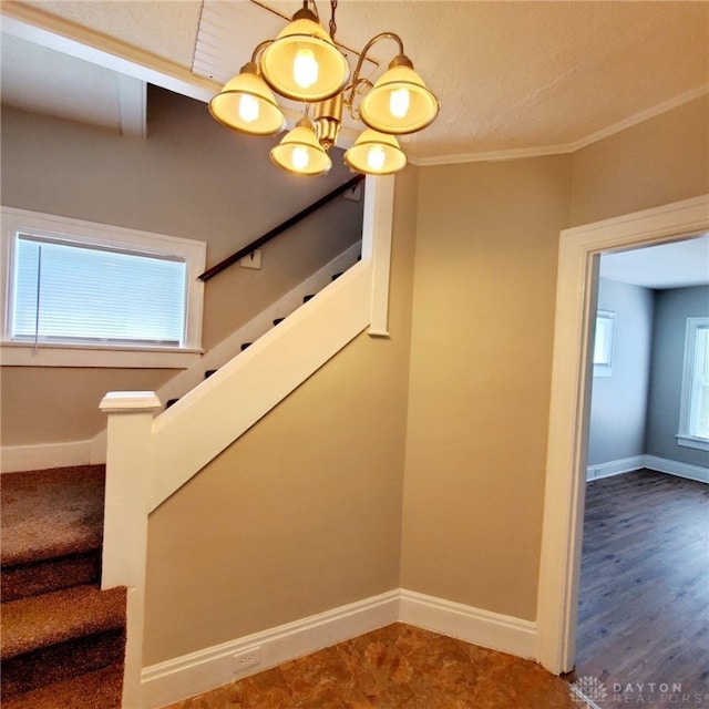 1271 Highland Ave, Dayton, OH 45410 - stairway featuring crown molding and a chandelier