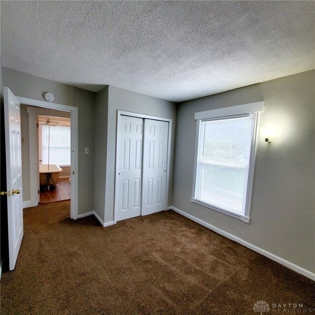 1271 Highland Ave, Dayton, OH 45410 - unfurnished bedroom with dark colored carpet and a closet