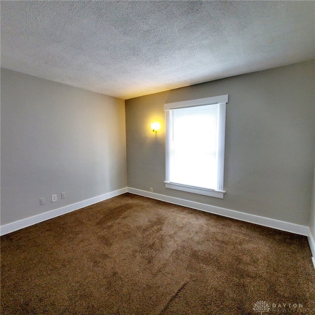 1271 Highland Ave, Dayton, OH 45410 - empty room with dark colored carpet and a textured ceiling