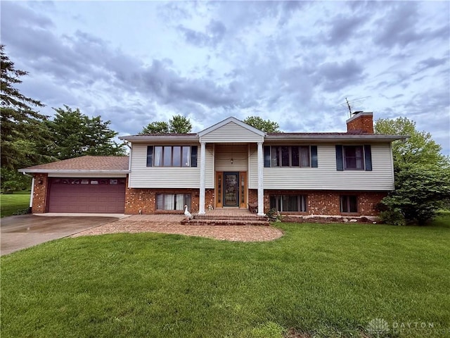 5778 Cedarwood Dr, Lewisburg, OH 45338 - split foyer home with a garage, a chimney, a front lawn, and brick siding