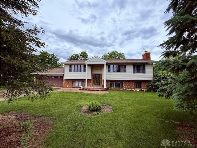 5778 Cedarwood Dr, Lewisburg, OH 45338 - raised ranch featuring a chimney, a front yard, a garage, and brick siding