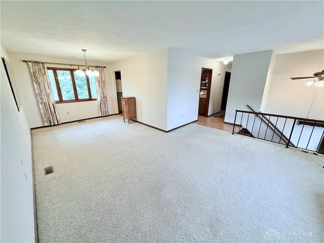 5778 Cedarwood Dr, Lewisburg, OH 45338 - carpeted spare room featuring baseboards, a ceiling fan, and a chandelier