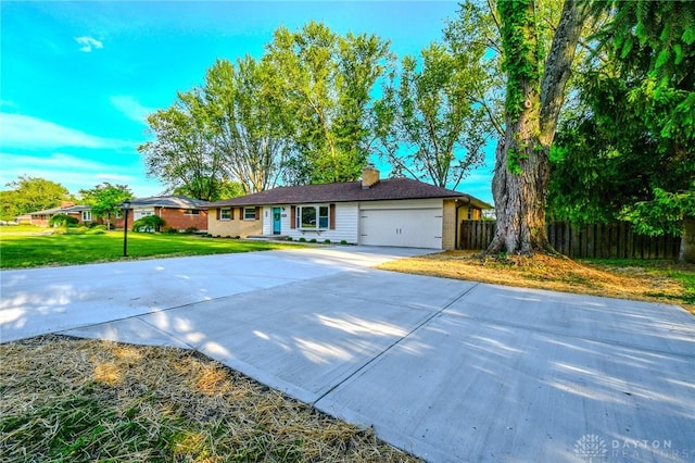 4189 W Franklin St, Bellbrook, OH 45305 - ranch-style house with concrete driveway, a garage, and a chimney