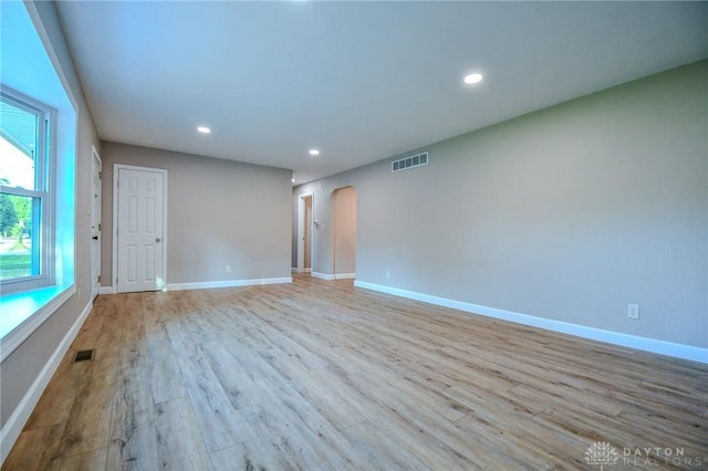 4189 W Franklin St, Bellbrook, OH 45305 - spare room featuring arched walkways, wood finished floors, and recessed lighting