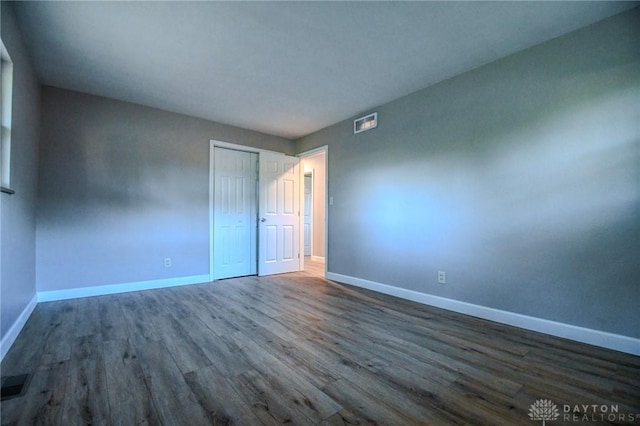 4189 W Franklin St, Bellbrook, OH 45305 - unfurnished bedroom with dark wood-style flooring and a closet