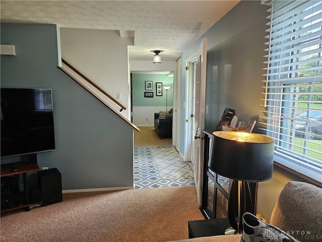 2547 Ryan Ct, Beavercreek, OH 45434 - hall featuring carpet floors, plenty of natural light, a textured ceiling, and stairs