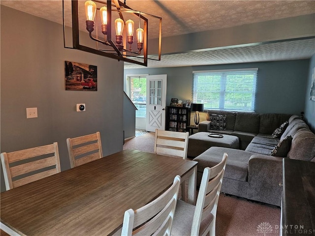 2547 Ryan Ct, Beavercreek, OH 45434 - carpeted dining area featuring a chandelier and a textured ceiling