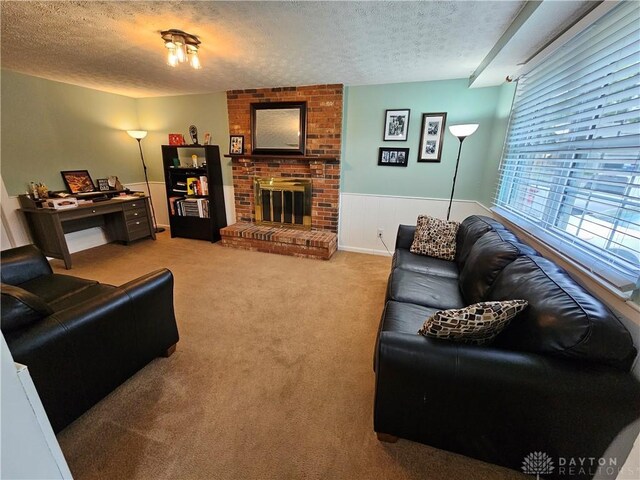 2547 Ryan Ct, Beavercreek, OH 45434 - carpeted living area featuring a textured ceiling, wainscoting, and a brick fireplace