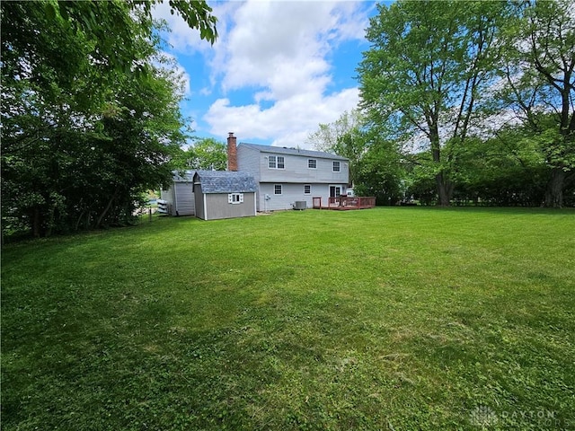 2547 Ryan Ct, Beavercreek, OH 45434 - view of grassy yard featuring a deck, an outdoor structure, and central AC