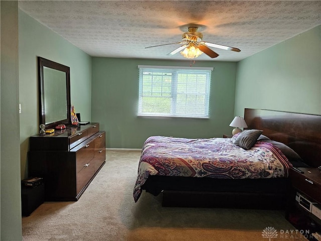 2547 Ryan Ct, Beavercreek, OH 45434 - bedroom featuring light carpet, a textured ceiling, ceiling fan, and baseboards