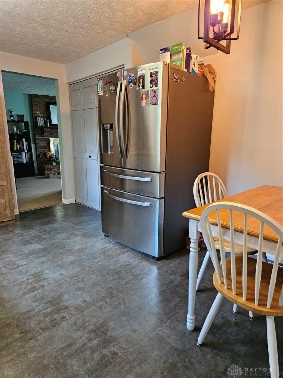 2547 Ryan Ct, Beavercreek, OH 45434 - kitchen with stainless steel fridge with ice dispenser, a textured ceiling, and a fireplace
