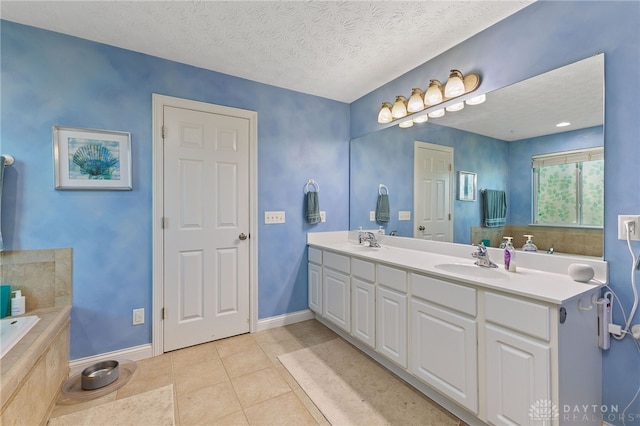 9300 Somerset Ct, Clearcreek Twp, OH 45458 - bathroom with double vanity, baseboards, a bath, tile patterned flooring, and a textured ceiling