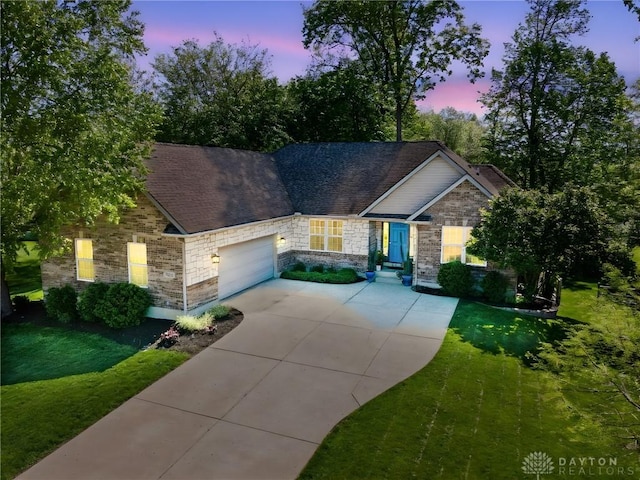 9300 Somerset Ct, Clearcreek Twp, OH 45458 - view of front facade with driveway, an attached garage, a front yard, and stone siding