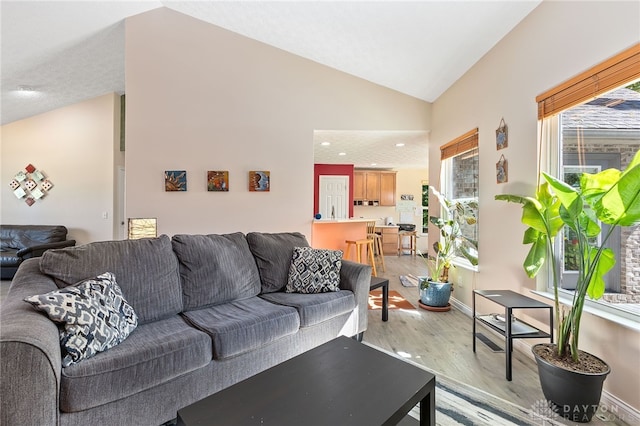 9300 Somerset Ct, Clearcreek Twp, OH 45458 - living room with light wood-type flooring, baseboards, recessed lighting, and high vaulted ceiling