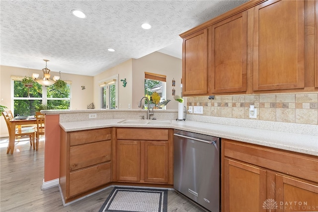 9300 Somerset Ct, Clearcreek Twp, OH 45458 - kitchen with dishwasher, a sink, a peninsula, light wood-style floors, and light countertops