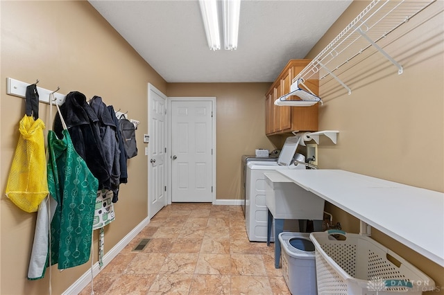 9300 Somerset Ct, Clearcreek Twp, OH 45458 - washroom featuring cabinet space, washer and dryer, stone finish flooring, and baseboards