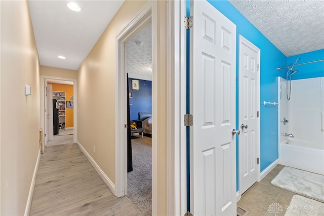 9300 Somerset Ct, Clearcreek Twp, OH 45458 - corridor with baseboards, light wood finished floors, a textured ceiling, and recessed lighting