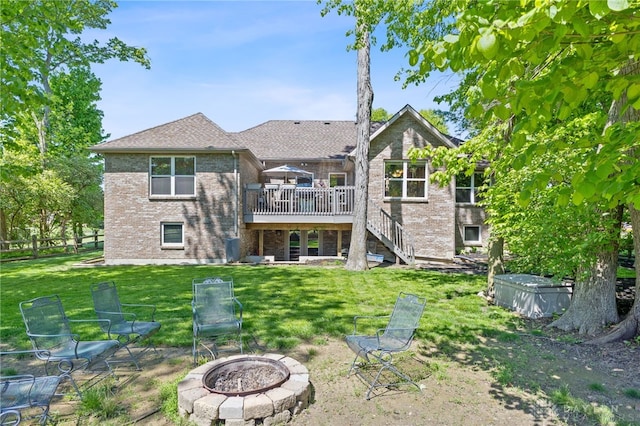 9300 Somerset Ct, Clearcreek Twp, OH 45458 - rear view of property with an outdoor fire pit, stairs, a wooden deck, a yard, and brick siding