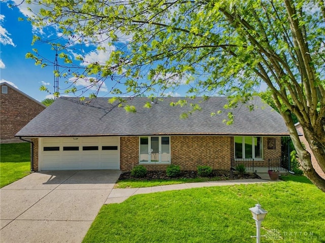 3339 Turner Dr, Springfield, OH 45504 - view of front of house featuring a shingled roof, brick siding, and a garage