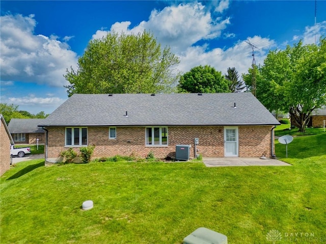 3339 Turner Dr, Springfield, OH 45504 - rear view of property with central air condition unit, a patio area, a yard, and a shingled roof