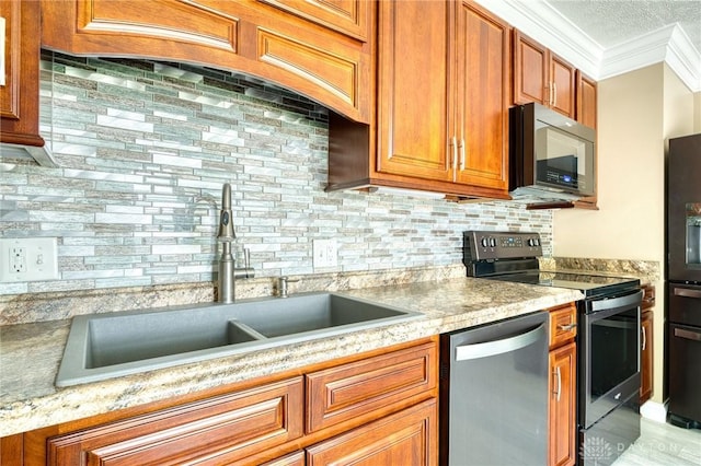 3339 Turner Dr, Springfield, OH 45504 - kitchen with appliances with stainless steel finishes, a sink, crown molding, brown cabinetry, and backsplash