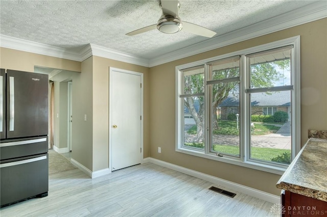 3339 Turner Dr, Springfield, OH 45504 - unfurnished dining area with a ceiling fan, a textured ceiling, light wood-type flooring, ornamental molding, and baseboards