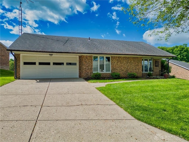 3339 Turner Dr, Springfield, OH 45504 - view of front of home featuring concrete driveway, brick siding, a front yard, and an attached garage
