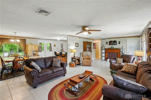 8590 Euphemia Castine Rd, Lewisburg, OH 45338 - living area featuring light tile patterned floors, ornamental molding, ceiling fan, and a chandelier