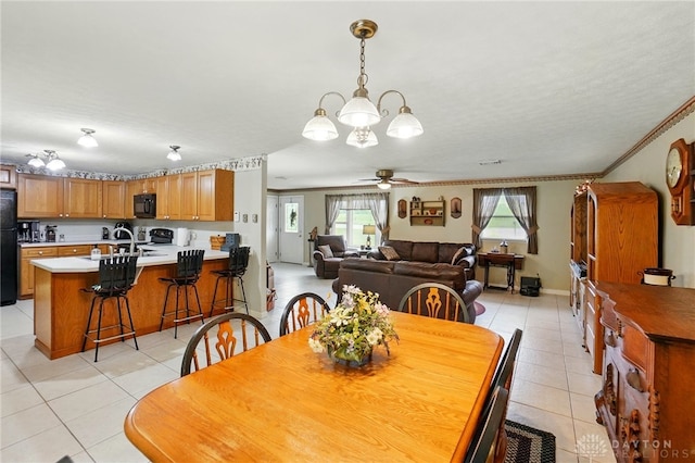 8590 Euphemia Castine Rd, Lewisburg, OH 45338 - dining space featuring light tile patterned floors, ceiling fan, ornamental molding, and a chandelier