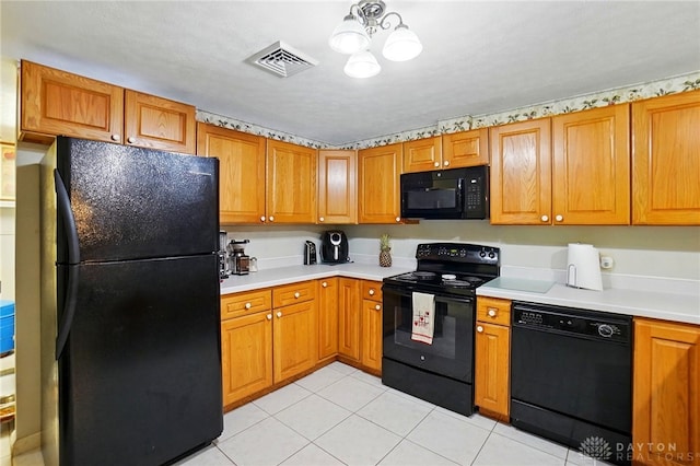 8590 Euphemia Castine Rd, Lewisburg, OH 45338 - kitchen featuring black appliances, light countertops, and brown cabinetry