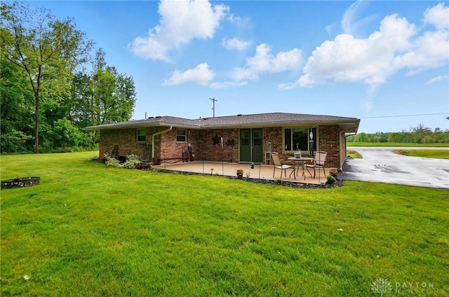8590 Euphemia Castine Rd, Lewisburg, OH 45338 - back of house with a patio area, a yard, and brick siding