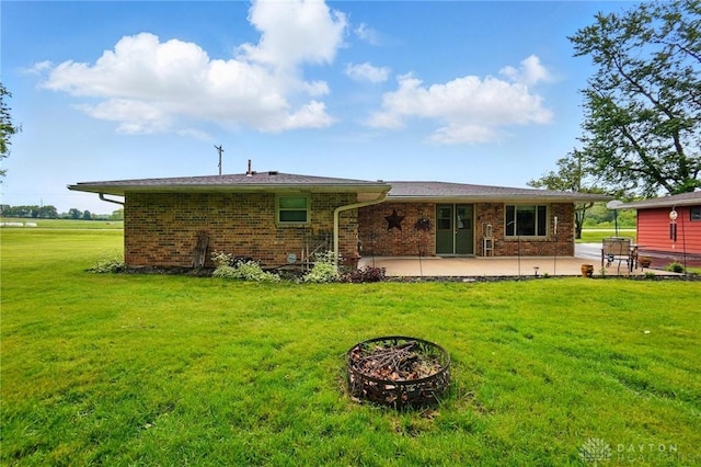 8590 Euphemia Castine Rd, Lewisburg, OH 45338 - back of house featuring a patio, a lawn, and brick siding