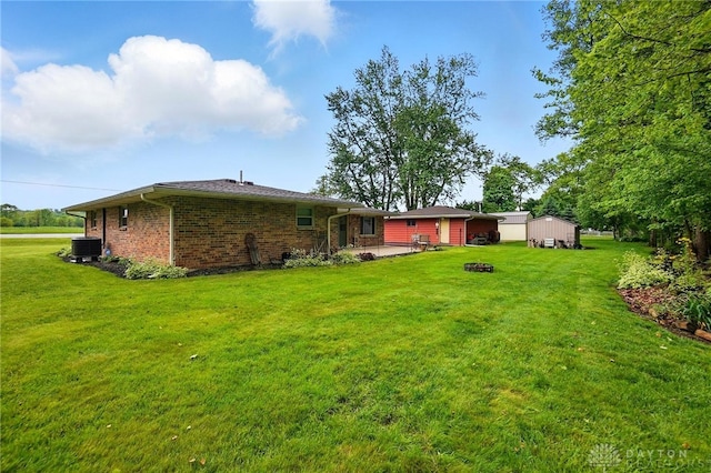 8590 Euphemia Castine Rd, Lewisburg, OH 45338 - view of grassy yard featuring central air condition unit and a patio area
