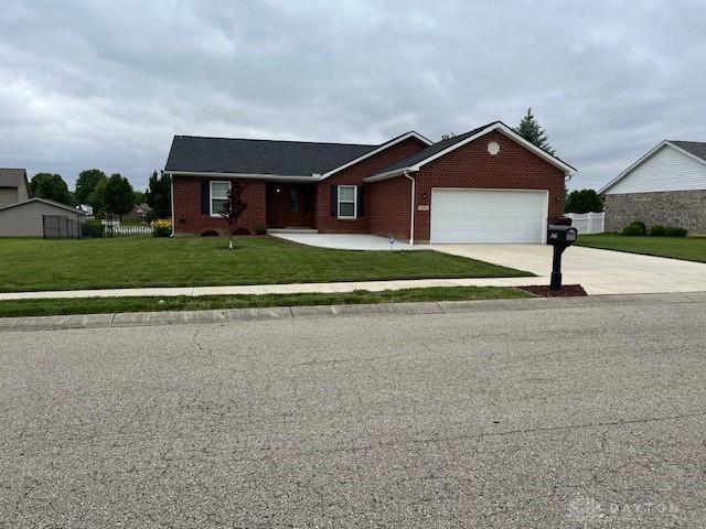 125 Honeysuckle Way, Eaton, OH 45320 - single story home with a garage, brick siding, and driveway