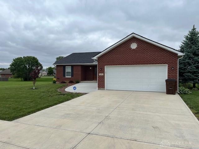 125 Honeysuckle Way, Eaton, OH 45320 - ranch-style home featuring a front lawn, a garage, concrete driveway, and brick siding