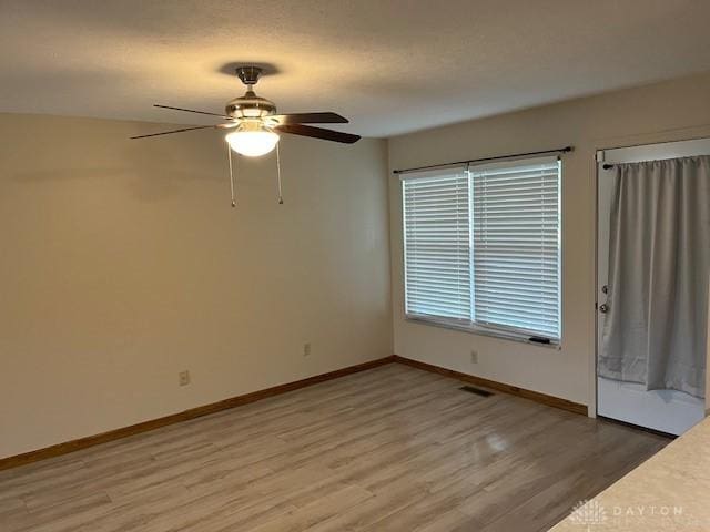 125 Honeysuckle Way, Eaton, OH 45320 - unfurnished room featuring light wood finished floors, a ceiling fan, and baseboards
