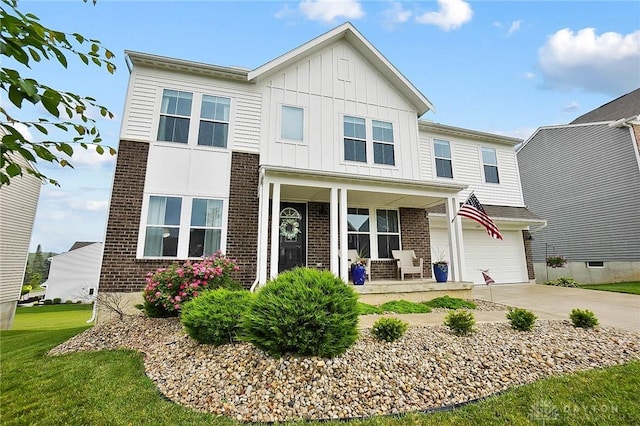 1691 Arden Bnd, Fairborn, OH 45324 - view of front of property with brick siding, covered porch, driveway, and board and batten siding