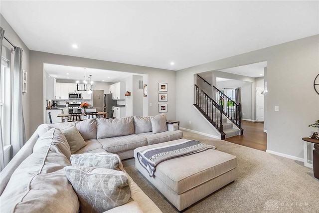 1691 Arden Bnd, Fairborn, OH 45324 - living room featuring carpet flooring, stairs, recessed lighting, baseboards, and a chandelier